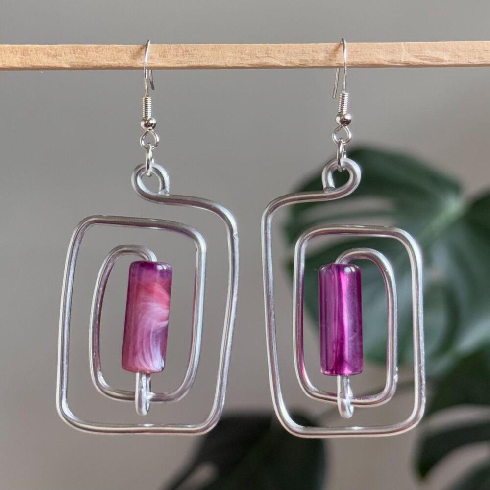 handmade silver wire spiral earrings with fuchsia purple tube beads.